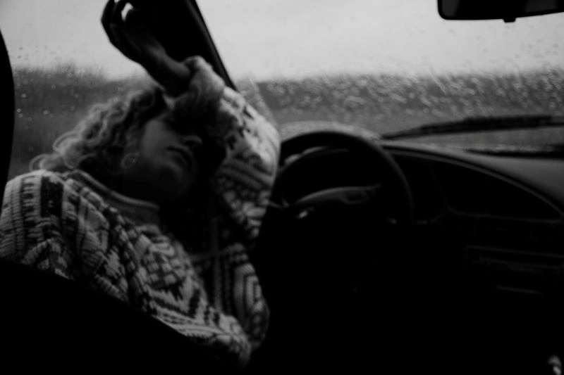 Can you drive after TMS therapy? A driver resting in a vehicle while considering safety after treatment.