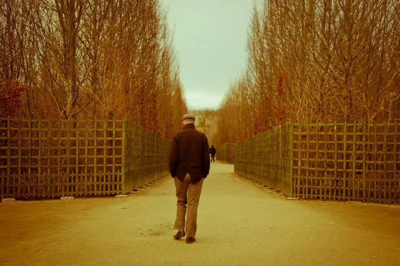 Memory lapse represented by a person walking alone, reflecting confusion, forgetfulness, or moments of losing track of thoughts.