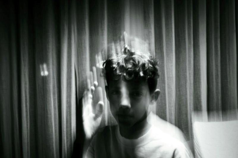 Memory lapse illustrated by a blurred person behind glass, symbolizing unclear memories and difficulty recalling information.