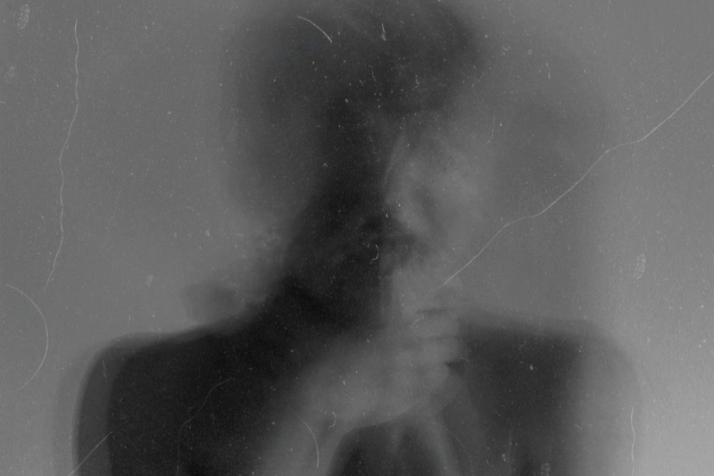 Blurred double-exposure portrait of a person, symbolizing distorted recollection and self-doubt often experienced with false memory OCD.